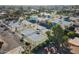 Aerial view of well-maintained community tennis courts featuring shaded seating, mature trees, and landscaping at 906 Leisure World --, Mesa, AZ 85206