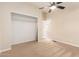 Bedroom featuring a closet, ceiling fan, neutral walls, and carpet with view of open doorway at 9431 E Coralbell Ave # 60, Mesa, AZ 85208