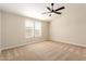 Bright bedroom featuring neutral walls, carpet, ceiling fan and plenty of natural light from the large window at 9431 E Coralbell Ave # 60, Mesa, AZ 85208