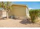 View of the well-maintained exterior, highlighting landscaping features and an efficient AC unit at 9431 E Coralbell Ave # 60, Mesa, AZ 85208