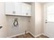 The well-lit laundry area provides convenience with built-in cabinetry for storage at 9431 E Coralbell Ave # 60, Mesa, AZ 85208