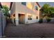 The backyard features gravel landscaping, covered patio, and partial privacy fencing at 10225 W Camelback Rd # 33, Phoenix, AZ 85037
