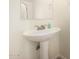 Bathroom featuring a pedestal sink, modern faucet and large mirror at 10225 W Camelback Rd # 33, Phoenix, AZ 85037