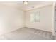 Carpeted bedroom with bright window. Doorway gives view to more of the home at 10225 W Camelback Rd # 33, Phoenix, AZ 85037
