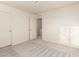 Cozy bedroom with neutral carpet, white walls, and a doorway leading to more of the home at 10225 W Camelback Rd # 33, Phoenix, AZ 85037