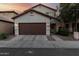 Charming two-story home with a well-maintained lawn, a two-car garage and inviting front entrance at 10225 W Camelback Rd # 33, Phoenix, AZ 85037