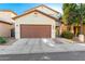 Charming two-story home with a well-maintained lawn, a two-car garage and inviting front entrance at 10225 W Camelback Rd # 33, Phoenix, AZ 85037