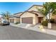 Charming two-story home with a well-maintained lawn, a two-car garage and inviting front entrance at 10225 W Camelback Rd # 33, Phoenix, AZ 85037