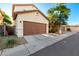 Charming two-story home with a well-maintained lawn, a two-car garage and inviting front entrance at 10225 W Camelback Rd # 33, Phoenix, AZ 85037