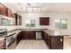 Updated kitchen featuring stainless steel appliances, brown cabinets and tile backsplash at 10225 W Camelback Rd # 33, Phoenix, AZ 85037