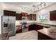 Modern kitchen with stainless steel appliances, dark wood cabinets, and ample counter space at 10225 W Camelback Rd # 33, Phoenix, AZ 85037