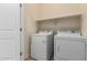 Functional laundry room features a washer, dryer, and overhead shelf at 10225 W Camelback Rd # 33, Phoenix, AZ 85037