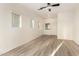 Bright living room featuring gray laminate flooring and a ceiling fan at 10225 W Camelback Rd # 33, Phoenix, AZ 85037