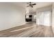 Open-concept living room featuring laminate flooring and access to the kitchen at 10225 W Camelback Rd # 33, Phoenix, AZ 85037