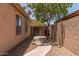 Landscaped backyard with rock and concrete walk-way, block fence, and covered patio at 10318 E Plata Ave, Mesa, AZ 85212