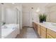 Bright bathroom features a soaking tub, walk-in shower, and double sink vanity at 10318 E Plata Ave, Mesa, AZ 85212