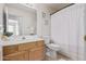 Bathroom with single sink vanity, toilet and shower with white striped curtain at 10318 E Plata Ave, Mesa, AZ 85212