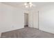 Bedroom with neutral carpet and paint features sliding door closet and ceiling fan at 10318 E Plata Ave, Mesa, AZ 85212