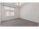 Well-lit bedroom with neutral carpet, ceiling fan, and window with blinds at 10318 E Plata Ave, Mesa, AZ 85212
