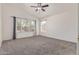 Spacious bedroom with ceiling fan and large windows for plenty of natural light at 10318 E Plata Ave, Mesa, AZ 85212