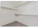 Walk-in closet with carpeted floors and shelving with closet rods on the wall at 10318 E Plata Ave, Mesa, AZ 85212