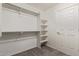 Walk-in closet boasts carpet floors, a closet rod, and built-in shelving at 10318 E Plata Ave, Mesa, AZ 85212