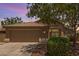 Charming home exterior featuring a two-car garage, tile roof, and well-maintained landscaping at 10318 E Plata Ave, Mesa, AZ 85212