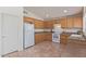 Spacious kitchen boasts tile flooring, wooden cabinets, and ample counter space at 10318 E Plata Ave, Mesa, AZ 85212