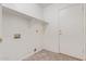 Laundry room with tile floor, shelf, and exterior door at 10318 E Plata Ave, Mesa, AZ 85212