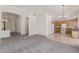 Open-concept living area leading into a kitchen with tile flooring and light wood cabinets at 10318 E Plata Ave, Mesa, AZ 85212