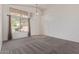 Bright living room featuring large windows, neutral carpet, and a welcoming ambiance at 10318 E Plata Ave, Mesa, AZ 85212