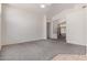 Large living room with neutral walls, carpet, ceiling fan and an open floor plan at 10318 E Plata Ave, Mesa, AZ 85212