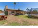 Large backyard featuring a covered patio, fenced pool area, trampoline, and well maintained lawn at 1263 W Del Rio St, Chandler, AZ 85224