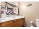 Bathroom with vanity, large mirror, decorative lighting, and toilet with towel rack at 1263 W Del Rio St, Chandler, AZ 85224