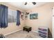 Small bedroom with a window and desk in neutral colors with ceiling fan and decorations at 1263 W Del Rio St, Chandler, AZ 85224