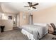 Bedroom with carpet and queen bed in neutral colors with ceiling fan and decorations at 1263 W Del Rio St, Chandler, AZ 85224