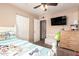 Bedroom with carpet and a twin size bed, ceiling fan and decorations at 1263 W Del Rio St, Chandler, AZ 85224