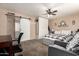 Spacious bedroom featuring a sliding barn door, ceiling fan, large bed and closet at 1263 W Del Rio St, Chandler, AZ 85224