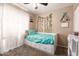 Cozy bedroom featuring a full sized bed with a decorative curtain, ivy wall decor, and a small whiteboard at 1263 W Del Rio St, Chandler, AZ 85224