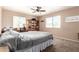 Bedroom with desk, shelving, ceiling fan, and a queen size bed with gray comforter at 1263 W Del Rio St, Chandler, AZ 85224