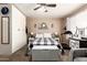 Comfortable bedroom with a ceiling fan, a large bed, dresser and storage closet at 1263 W Del Rio St, Chandler, AZ 85224