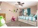 Bright bedroom with a ceiling fan and a large bed with drawers and fun decorations at 1263 W Del Rio St, Chandler, AZ 85224