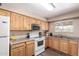 Efficient kitchen featuring wooden cabinetry, essential appliances, and ample counter space at 1263 W Del Rio St, Chandler, AZ 85224