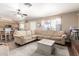 Open-concept living room featuring a sectional sofa, fireplace, and seamless flow into the kitchen area at 1263 W Del Rio St, Chandler, AZ 85224