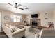 Comfortable living room with a large sectional sofa, brick fireplace, and ample natural light at 1263 W Del Rio St, Chandler, AZ 85224