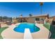 Backyard with a sparkling pool, diving board, poolside seating, covered patio, and green lawn at 1263 W Del Rio St, Chandler, AZ 85224