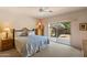 Comfortable bedroom featuring a ceiling fan and sliding glass doors to the outside patio at 12642 N Mountainside Dr # D, Fountain Hills, AZ 85268