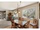 Light-filled dining area featuring tile floors, a decorative chandelier, and views of the surrounding landscape at 12642 N Mountainside Dr # D, Fountain Hills, AZ 85268