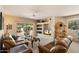 Cozy living room with built-in shelving, a ceiling fan, and sliding glass doors to the outside at 12642 N Mountainside Dr # D, Fountain Hills, AZ 85268
