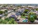Aerial view of a residential neighborhood showcasing homes with pools, solar panels, and lush landscaping at 14161 W Poinsettia Dr, Surprise, AZ 85379